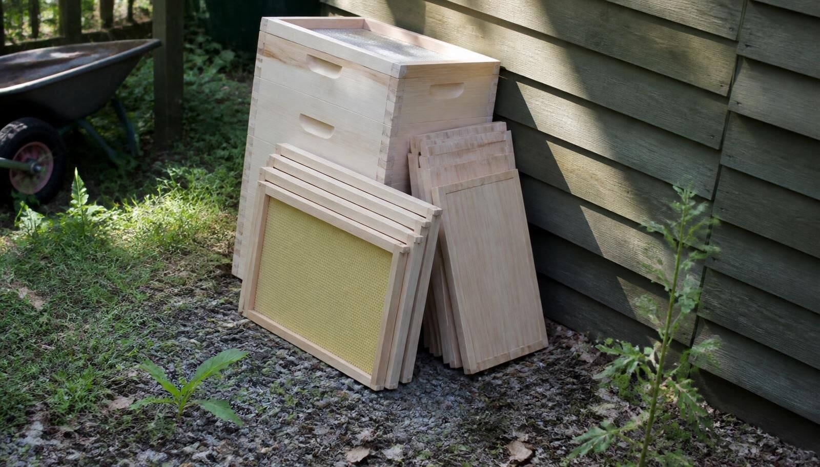 New Hive Boxes And Frames Stacked Against A Garden Shed Ready
